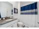 Bathroom with white cabinets, gray countertop, and stylish shower curtain at 3010 Camden Way, Davenport, FL 33837