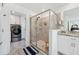 Bathroom featuring modern walk-in shower, vanity, and laundry in a convenient layout at 3010 Camden Way, Davenport, FL 33837