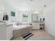 Spacious bathroom features a soaking tub, double vanity, and neutral tile flooring at 3010 Camden Way, Davenport, FL 33837
