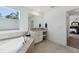 Spacious bathroom featuring a soaking tub, dual vanities, and modern fixtures at 3010 Camden Way, Davenport, FL 33837