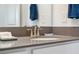 Close-up of bathroom vanity with gray countertop, modern faucet, and ample counter space at 3010 Camden Way, Davenport, FL 33837
