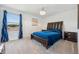 Bedroom featuring plush blue bedding, dark wood furniture, and a calming atmosphere at 3010 Camden Way, Davenport, FL 33837