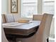 Dining room showcasing a dark wood table with decorative runner, set in front of a bright window at 3010 Camden Way, Davenport, FL 33837