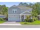 Beautiful two-story home with a manicured lawn, neutral paint, and a two-car garage at 3010 Camden Way, Davenport, FL 33837