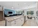 Open kitchen with a large island, stainless steel appliances, and a cozy dining area at 3010 Camden Way, Davenport, FL 33837