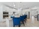 Modern kitchen featuring a large island with seating and stainless steel appliances at 3010 Camden Way, Davenport, FL 33837