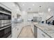 Well-lit kitchen with a large island, granite countertops, and stainless steel appliances at 3010 Camden Way, Davenport, FL 33837