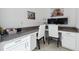 Bright home office featuring built-in cabinets, a spacious countertop, and comfortable seating for two at 3010 Camden Way, Davenport, FL 33837