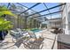Relaxing screened-in pool area with spa, lounge chairs, and an expansive patio perfect for outdoor living at 3010 Camden Way, Davenport, FL 33837