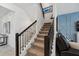 Staircase with carpeted steps, black railing, and blue accent wall at 3010 Camden Way, Davenport, FL 33837