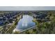 Scenic aerial view of a neighborhood with a central lake, fountain, lush landscaping, and colorful townhomes on a sunny day at 4002 San Gallo Dr # 106, Kissimmee, FL 34741