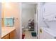 Compact bathroom setup with a stacked washer and dryer and a combined bath/shower at 4002 San Gallo Dr # 106, Kissimmee, FL 34741