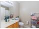 Bright bathroom with a vanity, mirror, toilet, and a shower with a patterned curtain at 4002 San Gallo Dr # 106, Kissimmee, FL 34741