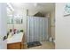 Standard bathroom with a seashell-patterned shower curtain and neutral tile flooring at 4002 San Gallo Dr # 106, Kissimmee, FL 34741