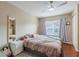 Comfortable bedroom featuring neutral tones, plush bedding, and wood flooring at 4002 San Gallo Dr # 106, Kissimmee, FL 34741