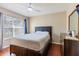 Well-lit bedroom with neutral walls, a ceiling fan, and a wooden bed frame at 4002 San Gallo Dr # 106, Kissimmee, FL 34741