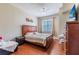 Cozy bedroom with a large window, ceiling fan, and a wooden bed frame at 4002 San Gallo Dr # 106, Kissimmee, FL 34741
