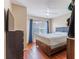 Inviting bedroom featuring a ceiling fan, wooden bed frame, and warm-toned walls at 4002 San Gallo Dr # 106, Kissimmee, FL 34741