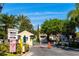 Community entrance with a guard house, signage, and landscaped surroundings at 4002 San Gallo Dr # 106, Kissimmee, FL 34741