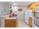 Bright kitchen with ample counter space, white appliances, and neutral flooring at 4002 San Gallo Dr # 106, Kissimmee, FL 34741