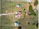 Overhead aerial view of a single-Gathering home with a long driveway and outbuildings at 41636 Outlaw Ln, Weirsdale, FL 32195