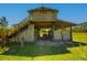 Spacious barn with tractor featuring a raised structure, open design, and ample storage for equipment at 41636 Outlaw Ln, Weirsdale, FL 32195