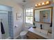 Well-lit bathroom with a modern vanity, stylish mirror, and walk-in shower at 41636 Outlaw Ln, Weirsdale, FL 32195