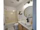 Bright bathroom featuring modern fixtures, a spacious vanity, and shower-tub combo at 41636 Outlaw Ln, Weirsdale, FL 32195