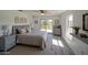 A cozy bedroom with natural light, deck access, complemented by neutral tones and wooden furniture at 41636 Outlaw Ln, Weirsdale, FL 32195