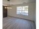 Dining room featuring a sliding barn door and a stylish light fixture at 41636 Outlaw Ln, Weirsdale, FL 32195