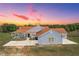Well-maintained one-story home with a shingle exterior and an expansive driveway at 41636 Outlaw Ln, Weirsdale, FL 32195