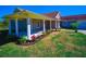 Charming single-story home with covered porch, manicured lawn, and colorful landscaping at 41636 Outlaw Ln, Weirsdale, FL 32195