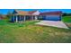 Lovely home with a covered porch, attached garage, and neatly landscaped front yard at 41636 Outlaw Ln, Weirsdale, FL 32195