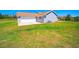 Well-maintained home featuring a two-car garage, green grass, and an AC unit at 41636 Outlaw Ln, Weirsdale, FL 32195