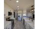 Modern kitchen features white cabinetry, stainless steel appliances, and a spacious island at 41636 Outlaw Ln, Weirsdale, FL 32195