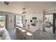 Modern kitchen featuring a large center island with seating, sleek white cabinets, and stainless steel appliances at 41636 Outlaw Ln, Weirsdale, FL 32195