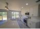 Bright kitchen with stainless steel appliances, sleek countertops, and an island with a sink at 41636 Outlaw Ln, Weirsdale, FL 32195