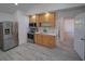 Kitchen featuring stainless steel appliances, ample counter space, and gray wood-look floors at 41636 Outlaw Ln, Weirsdale, FL 32195