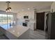 Modern kitchen featuring white cabinets, quartz countertops, stainless steel appliances, and a sliding barn door at 41636 Outlaw Ln, Weirsdale, FL 32195