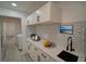 Clean kitchenette with ample counter space, modern appliances, and stylish tile backsplash at 41636 Outlaw Ln, Weirsdale, FL 32195