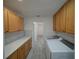 Updated laundry room featuring stylish cabinets and a spacious countertop, with new washer and dryer at 41636 Outlaw Ln, Weirsdale, FL 32195