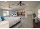 Large main bedroom featuring hardwood floors, ceiling fans, and kitchen/entertainment center at 41636 Outlaw Ln, Weirsdale, FL 32195