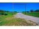 Beautiful country estate with long driveway leading to a single-story home and outbuildings at 41636 Outlaw Ln, Weirsdale, FL 32195