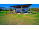 RV carport featuring ample space for parking a vehicle in a grassy yard with trees around at 41636 Outlaw Ln, Weirsdale, FL 32195