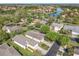 An aerial view shows the neighborhood's lush landscaping and a tranquil pond, creating a serene residential setting at 439 Madera Pass, Poinciana, FL 34759