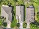 Aerial view of house with well-manicured lawn, mature trees, and neighboring homes at 439 Madera Pass, Poinciana, FL 34759