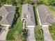 Aerial view of the house and surrounding manicured lawn and landscaping, including the driveway at 439 Madera Pass, Poinciana, FL 34759