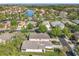 Aerial view of a community with single-Gathering homes, a lake, and mature trees at 439 Madera Pass, Poinciana, FL 34759