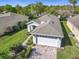 Aerial view shows a home's manicured lawn, paver driveway, and attached garage at 439 Madera Pass, Poinciana, FL 34759