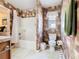 Full bathroom with a tub/shower combo, toilet, and colorful wallpaper, providing a functional space at 439 Madera Pass, Poinciana, FL 34759